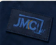 JMC embroidered label on navy fabric